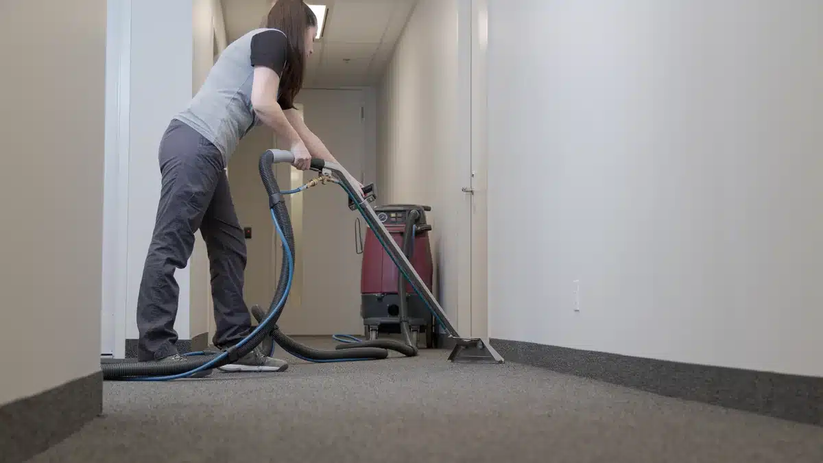 Carpet-cleaning equipment being used on a carpeted floor